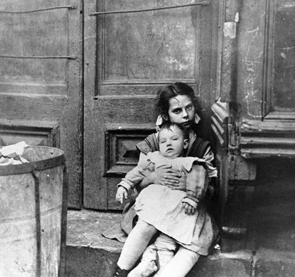 Girl Sitting on Doorstep with Baby on Her Lap