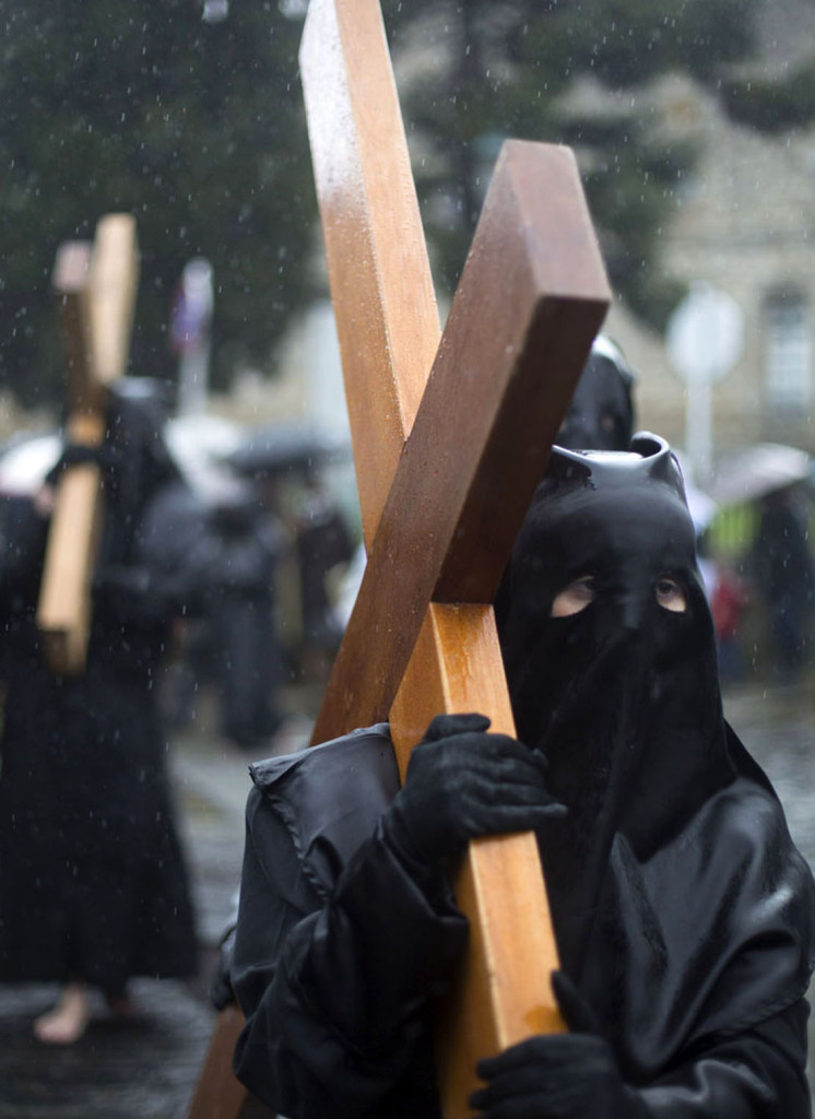 Penitents take part in the procession of the "Nuestra Senora de la Quinta Angustia" brotherhood during Holy Week in Santiago de Compostela