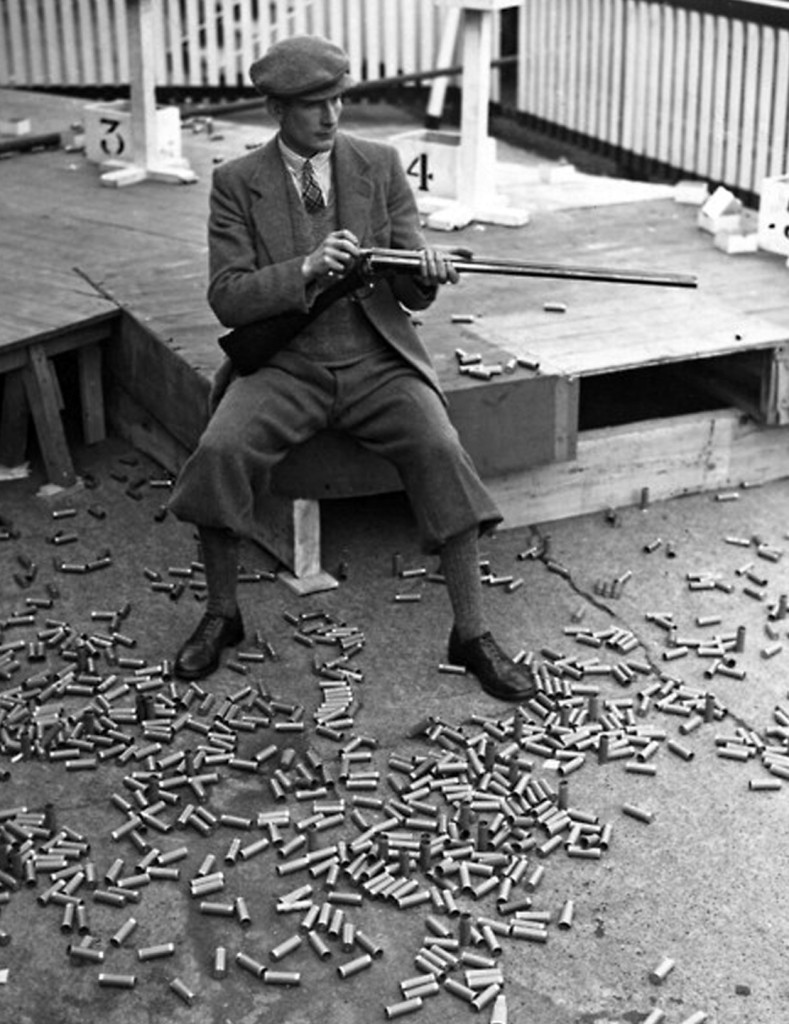 21st October 1938:  One of the competitors surrounded by empty cartridges at a clay pigeon shooting meeting at White City Stadium in London.  (Photo by Stevenson/Topical Press Agency/Getty Images)