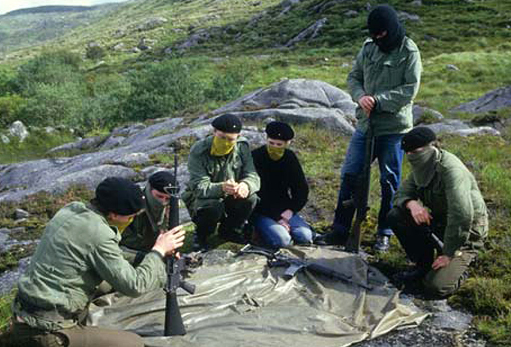 Donegal, Ireland Republic: In an unknown location in County Donegal in the woods in the countryside of Donegal city, The Irish Republican Army (IRA) trainees go through guerilla warfare tactics with automatic assault rifles in front of them while wearing military fatigues with berets decorated with Republican flag and their faces covered up. The trainee in the middle in black sweater is a young woman volunteer. (Photo by Kaveh Kazemi/Getty Images)