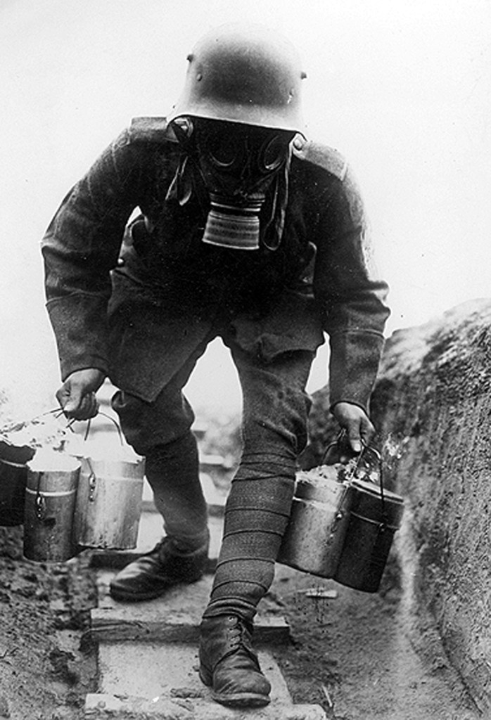 SZP353850 German soldier with gas mask carries food to a shelter, 1914-1918 (b/w photo) by German Photographer (20th Century); ¬© SZ Photo / Scherl; PERMISSION REQUIRED FOR USE OUTSIDE GERMANY, UK & USA; FRENCH RIGHTS NOT AVAILABLE; German,  out of copyright PLEASE NOTE: The Bridgeman Art Library works with the owner of this image to clear permission. If you wish to reproduce this image, please inform us so we can clear permission for you.