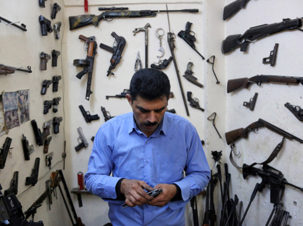 In this Wednesday, Feb. 25, 2015 photo, gunsmith Bahktiyar Sadr-Aldeen repairs a weapon at his shop, in Irbil, northern Iraq. Sadr-Aldeen, an Iraqi Kurd, has seen his business shoot up by 50 percent since last June, when the Islamic State took over the Iraqi city of Mosul. The Kurdish fighting force known as the pershmerga has been at war against the Sunni extremists ever since, keeping Aldeen busy. (AP Photo/Bram Janssen)