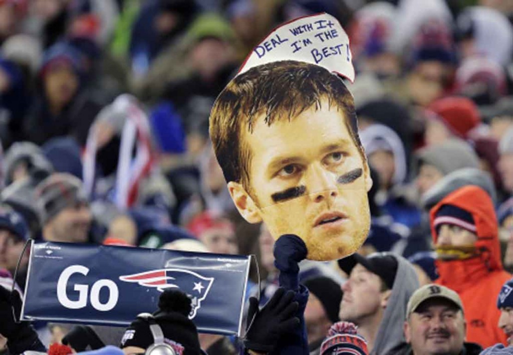 New England Patriots fans hold a picture and sign referring to Patriots quarterback Tom Brady in the first half of an NFL football game against the Buffalo Bills, Monday, Nov. 23, 2015, in Foxborough, Mass. (AP Photo/Charles Krupa)