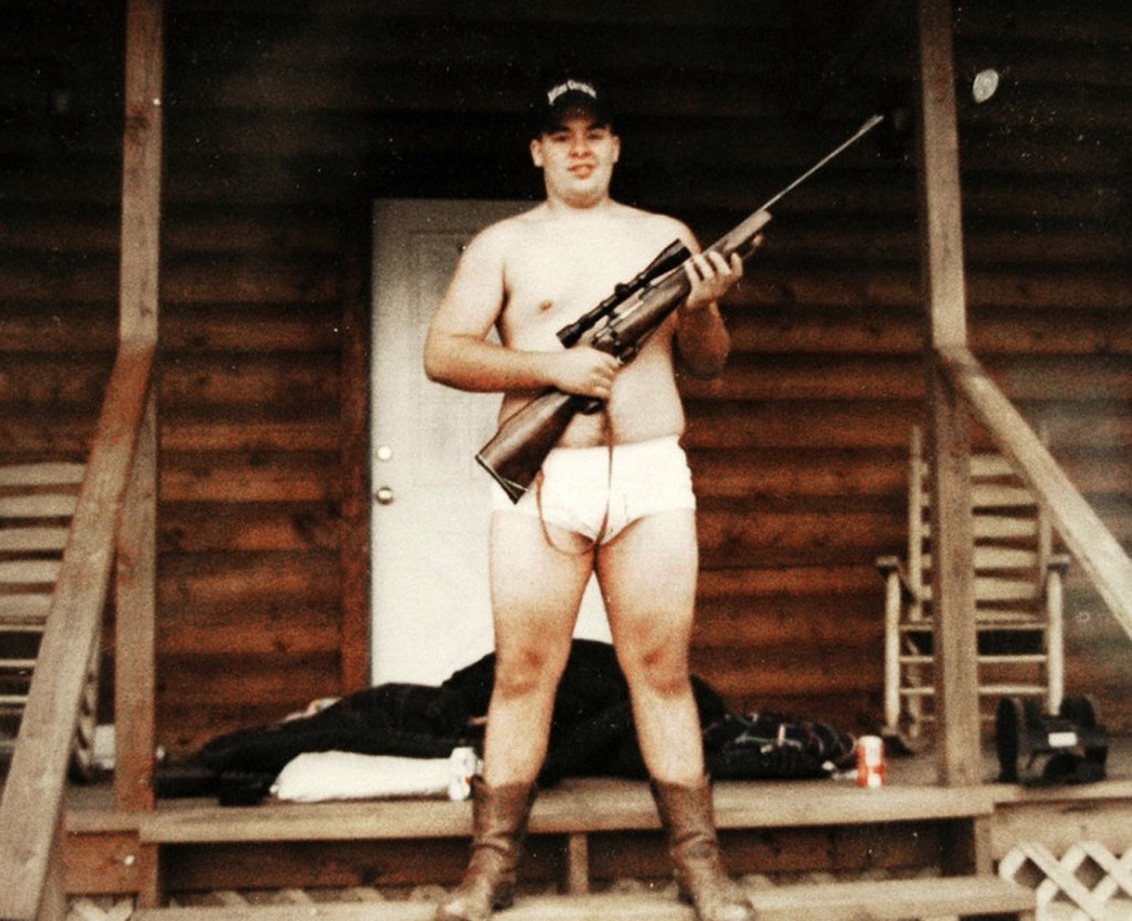 USA. Abilene, Texas. 2005. boy with gun on porch.