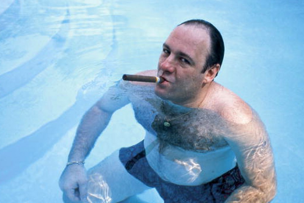 American actor James Gandolfini, as Tony Soprano, smokes a cigar while he stands in pool, in publicity still for the HBO cable TV series 'The Sopranos,' 1999. (Photo by Anthony Neste//Time Life Pictures/Getty Images)
