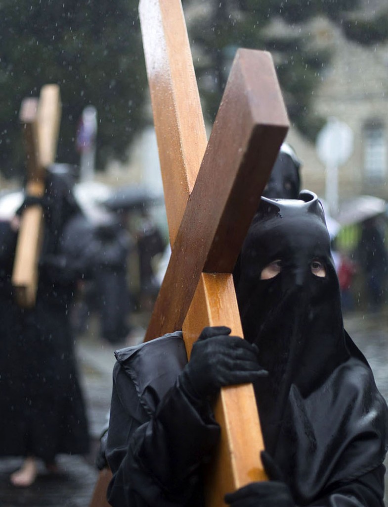 Penitents take part in the procession of the "Nuestra Senora de la Quinta Angustia" brotherhood during Holy Week in Santiago de Compostela