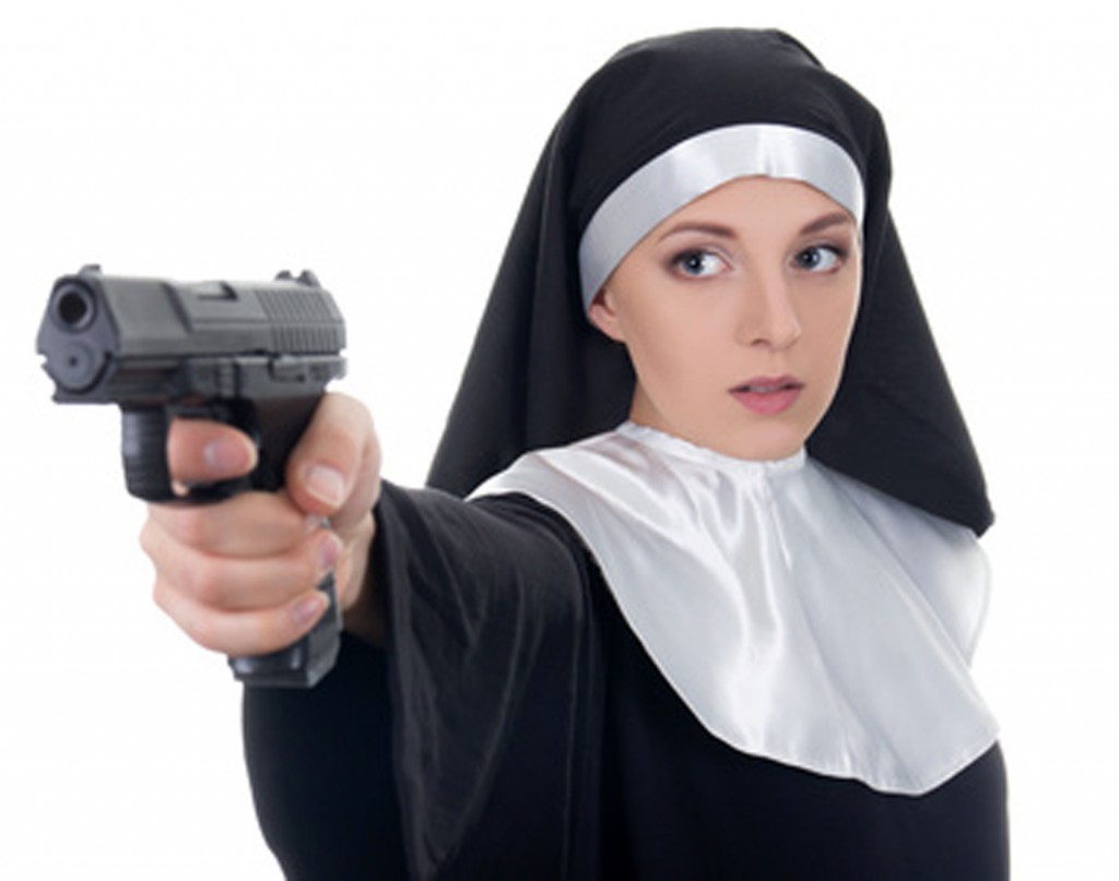 young woman nun shooting with gun isolated on white