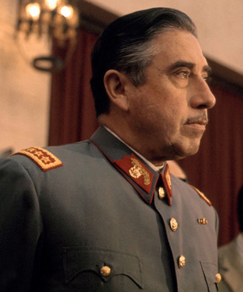 general-augusto-pinochet-head-of-chiles-ruling-military-junta-holds-a-picture-id515108946