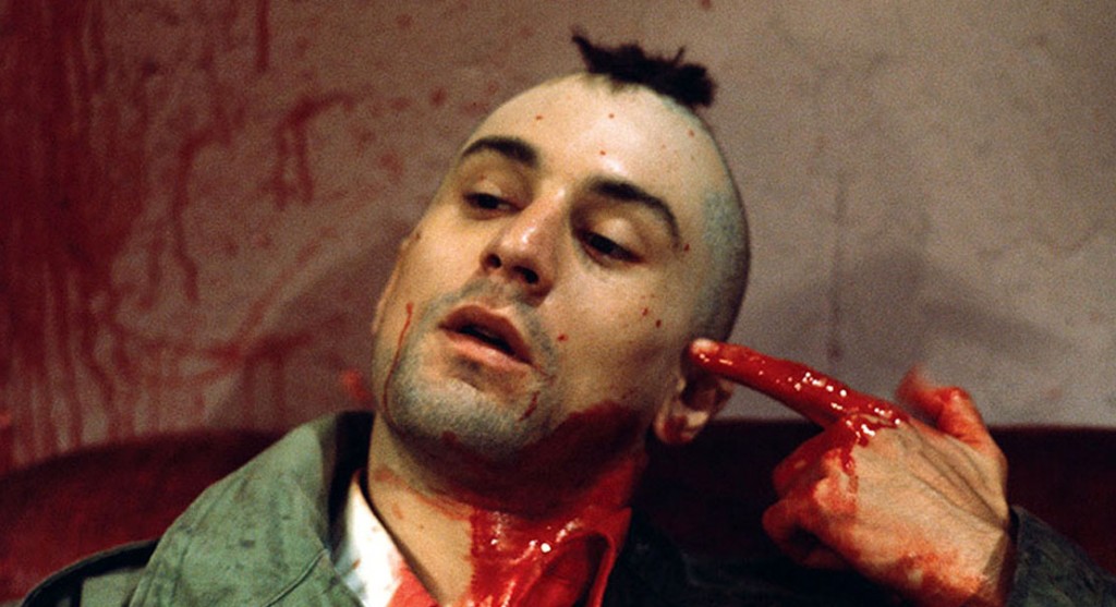 1976 --- Robert De Niro as Travis Bickle points a bloody finger at his head in a suicidal gesture on the set of Martin Scorsese's Taxi Driver. --- Image by © Steve Schapiro/Corbis
