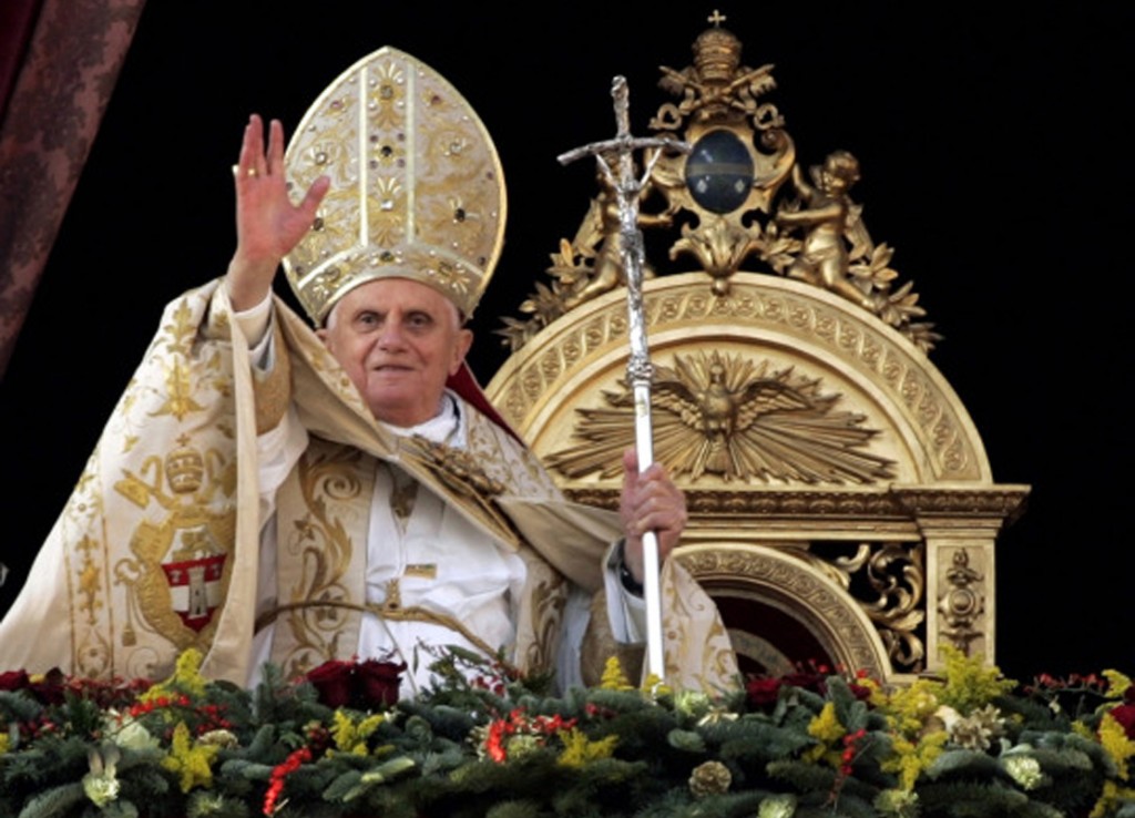 Pope Benedict XVI blesses pilgrims from the central balcony of St. Peter's Basilica at the Vatican Dec. 25 during his Christmas Day blessing "urbi et orbi" (to the city of Rome and the world). (CNS photo/Alessandro Bianchi, Reuters) (Dec. 26, 2007) See CHRISTMAS-MARINI Dec. 26, 2007.
