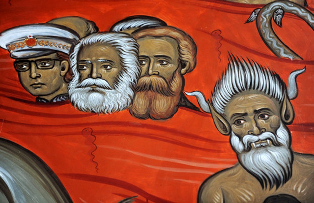 This picture taken on January 31, 2014, shows a fresco with the portraits of late German philosophers Karl Marx (2nd L) and Friedrich Engels (3rd L), alongside Yugoslav communist leader Tito (L) and a demon (R), painted in an Orthodox church fresco scene of sinners in hell, in the newly-built "Church of Resurrection" in Podgorica. AFP PHOTO / SAVO PRELEVIC
