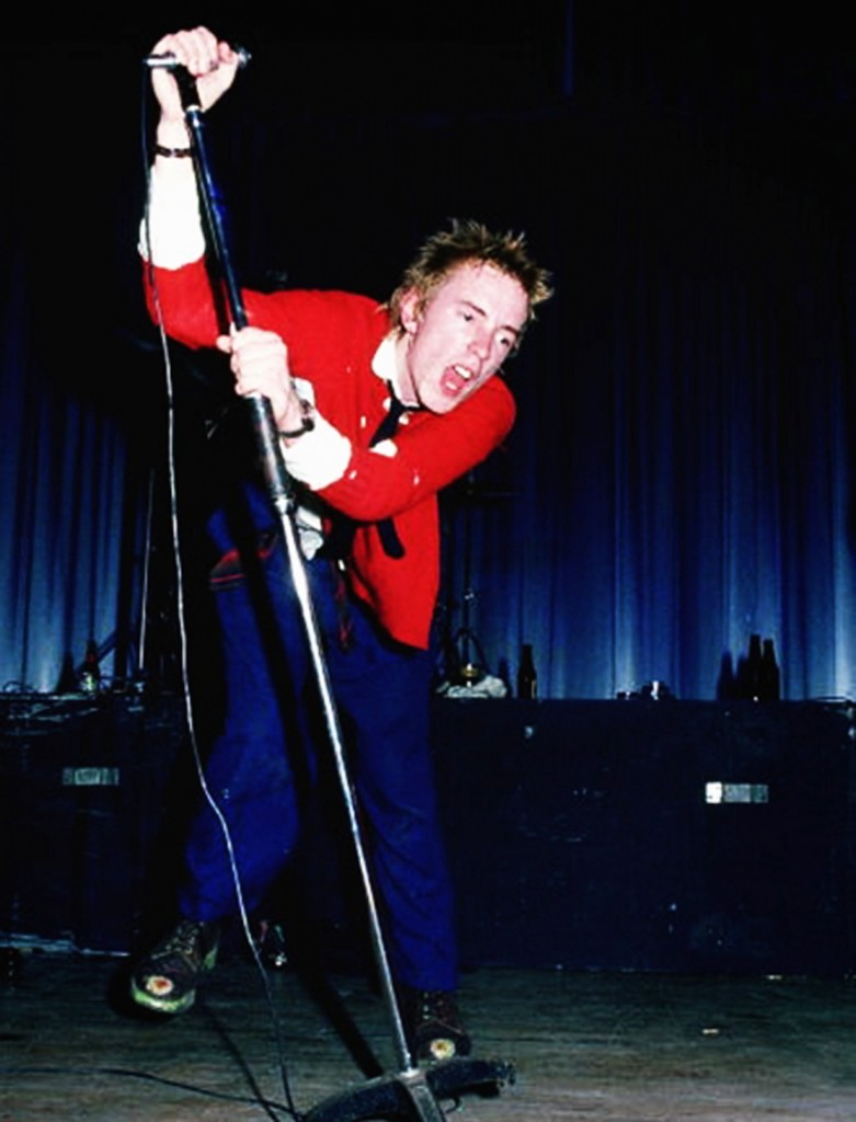 UNITED KINGDOM - OCTOBER 21:  Photo of SEX PISTOLS; Johnny Rotten (John Lydon) performing live onstage at Dunstable's Queensway Hall  (Photo by Chris Morphet/Redferns)